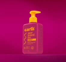 Curlit Wavy Leave-In Conditioner pump bottle on a pink background