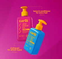 Curlit Wavy Hair Styling Kit pump bottles on a pink background