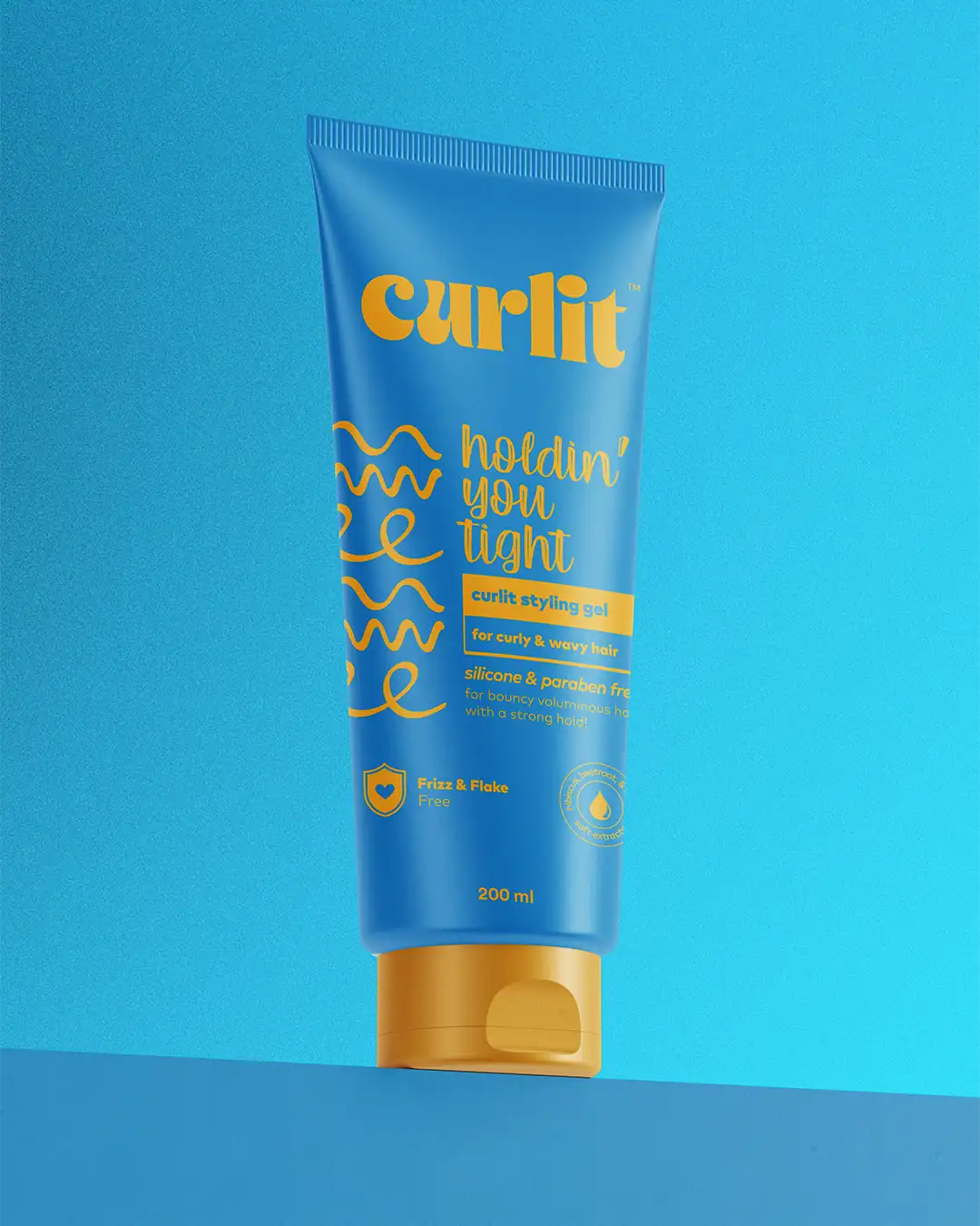 Vibrant blue Curlit styling gel tube for curly and wavy hair with yellow accents and text, placed against a matching blue background.