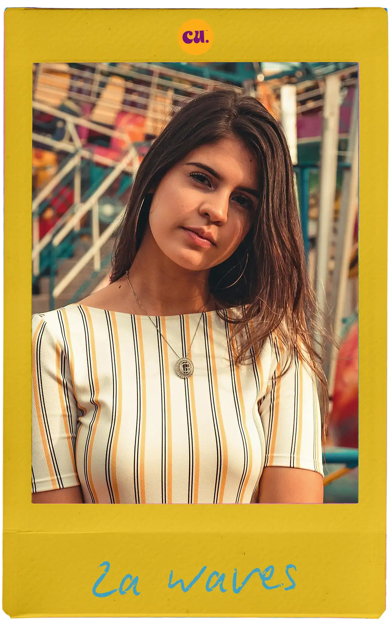 Girl with wavy brown hair in striped dress at carnival with colorful rides and attractions.