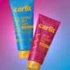 Vibrant hair styling products from Curlit in colorful tubes on a gradient background.